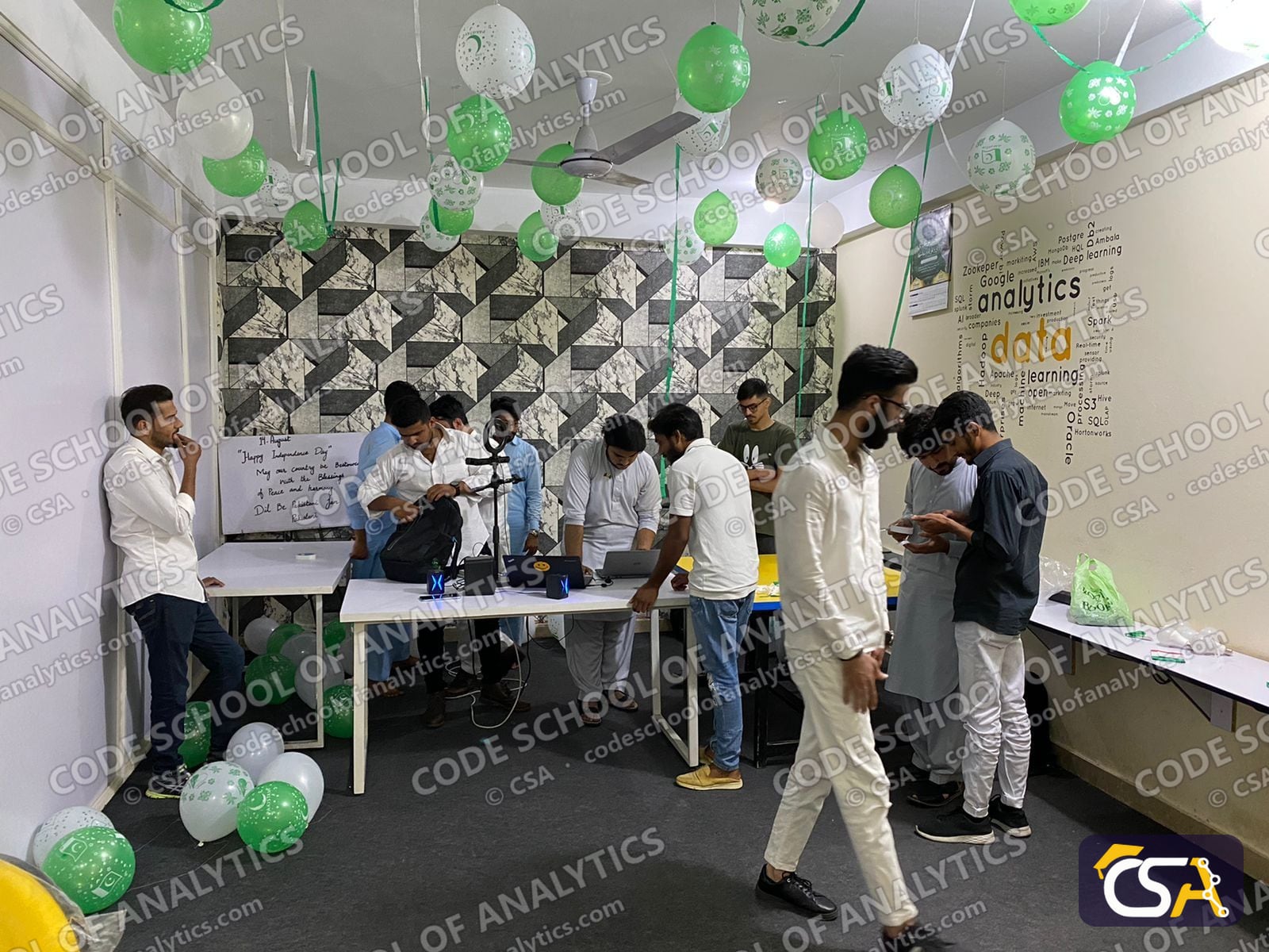 Students and staff around the decorated tables
