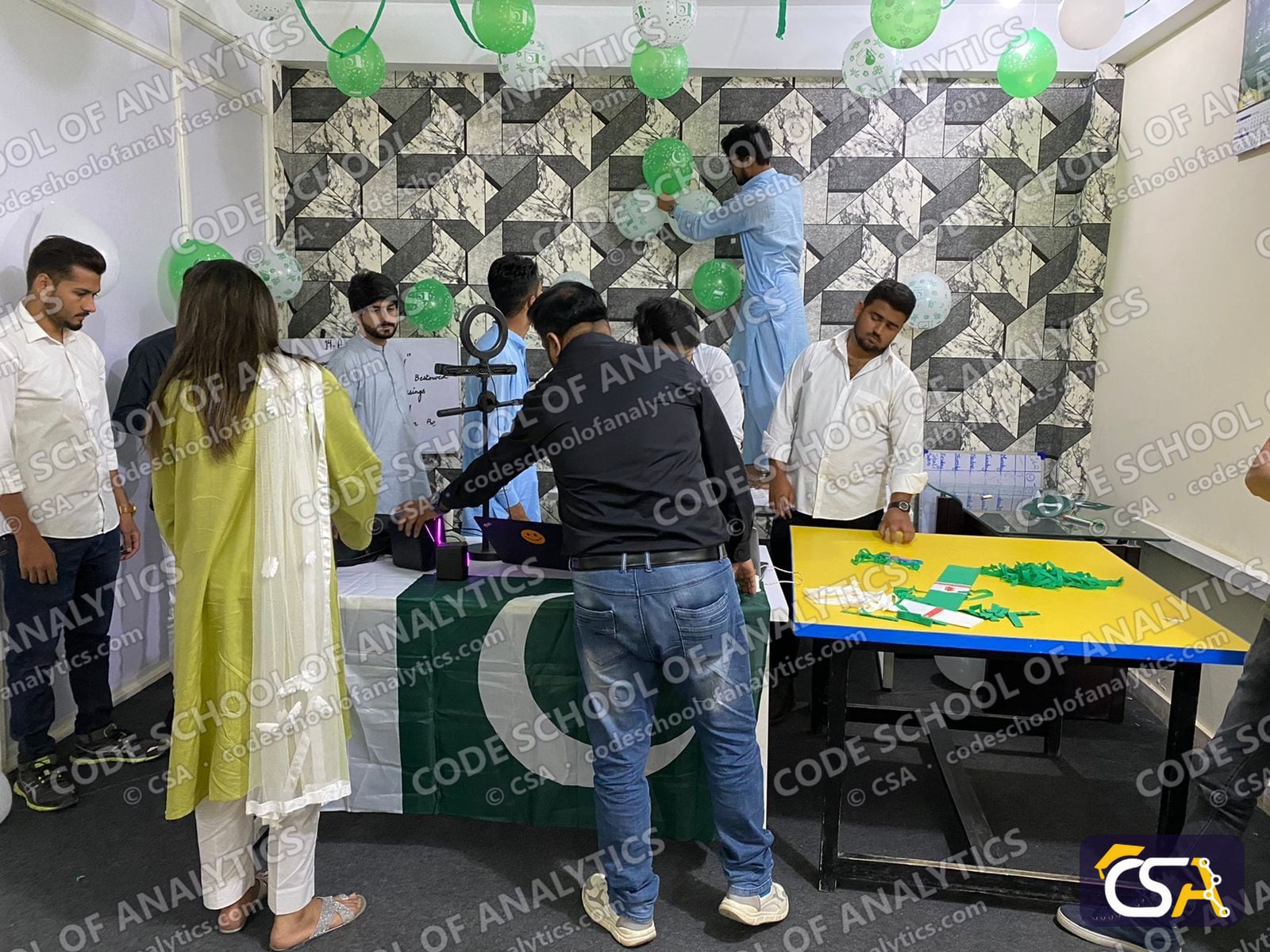 Preparing the decorations beside the Pakistan flag