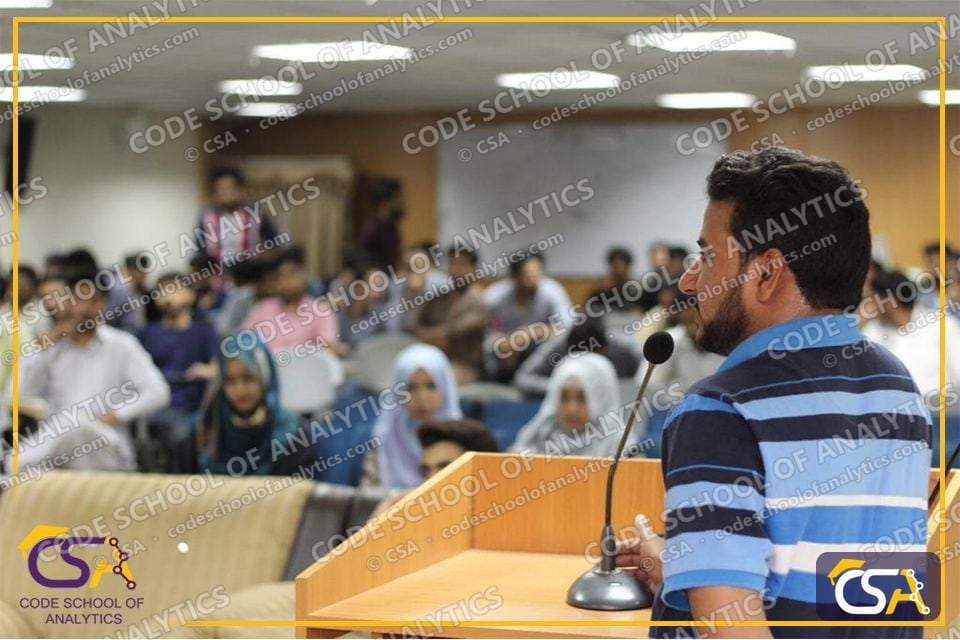 CSA speaker addressing a packed university auditorium at FUAAST