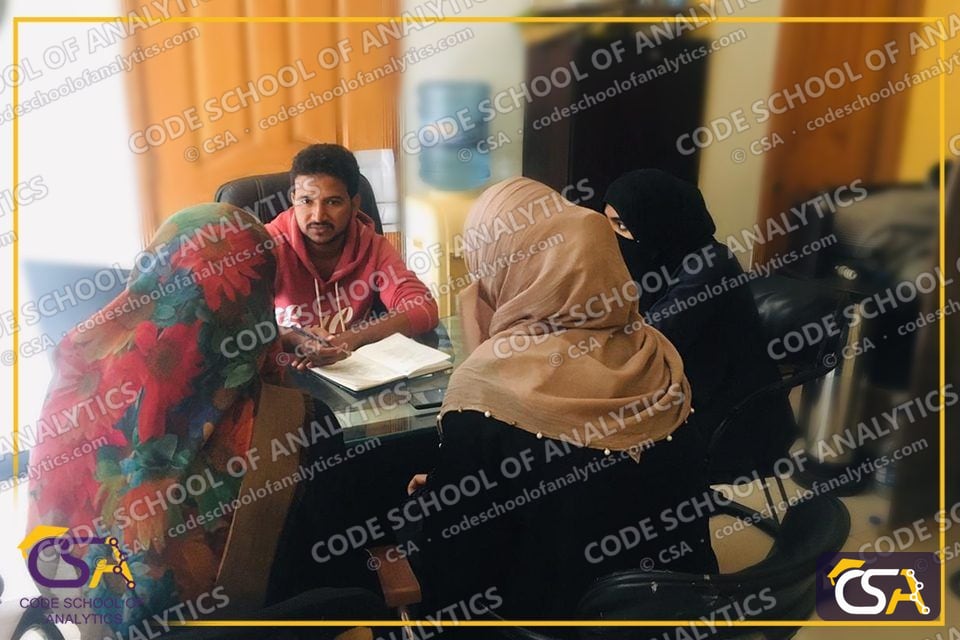 Mentor reviewing project notes with final-year students